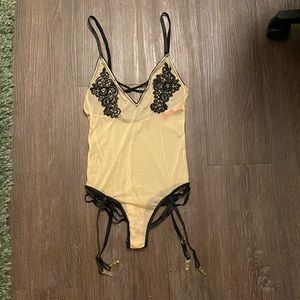 Beige mesh body suit with black details